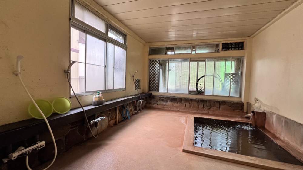 Large onsen bath filled with natural hotspring water.